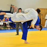 JMJC's Nick Kossor (blue uniform) throws opponent on his way to the 66kg title